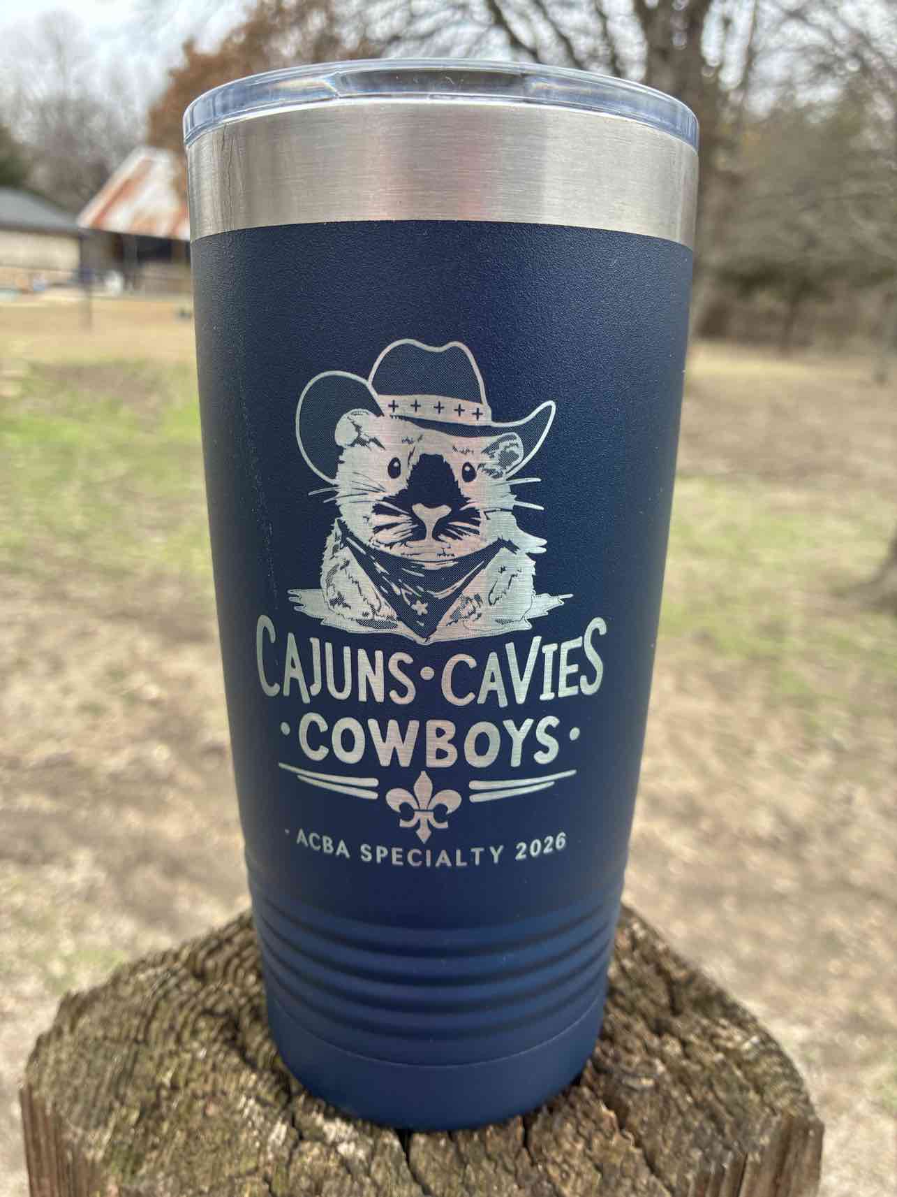 Navy blue tumbler with Cajuns Cavies Cowboys engraved design