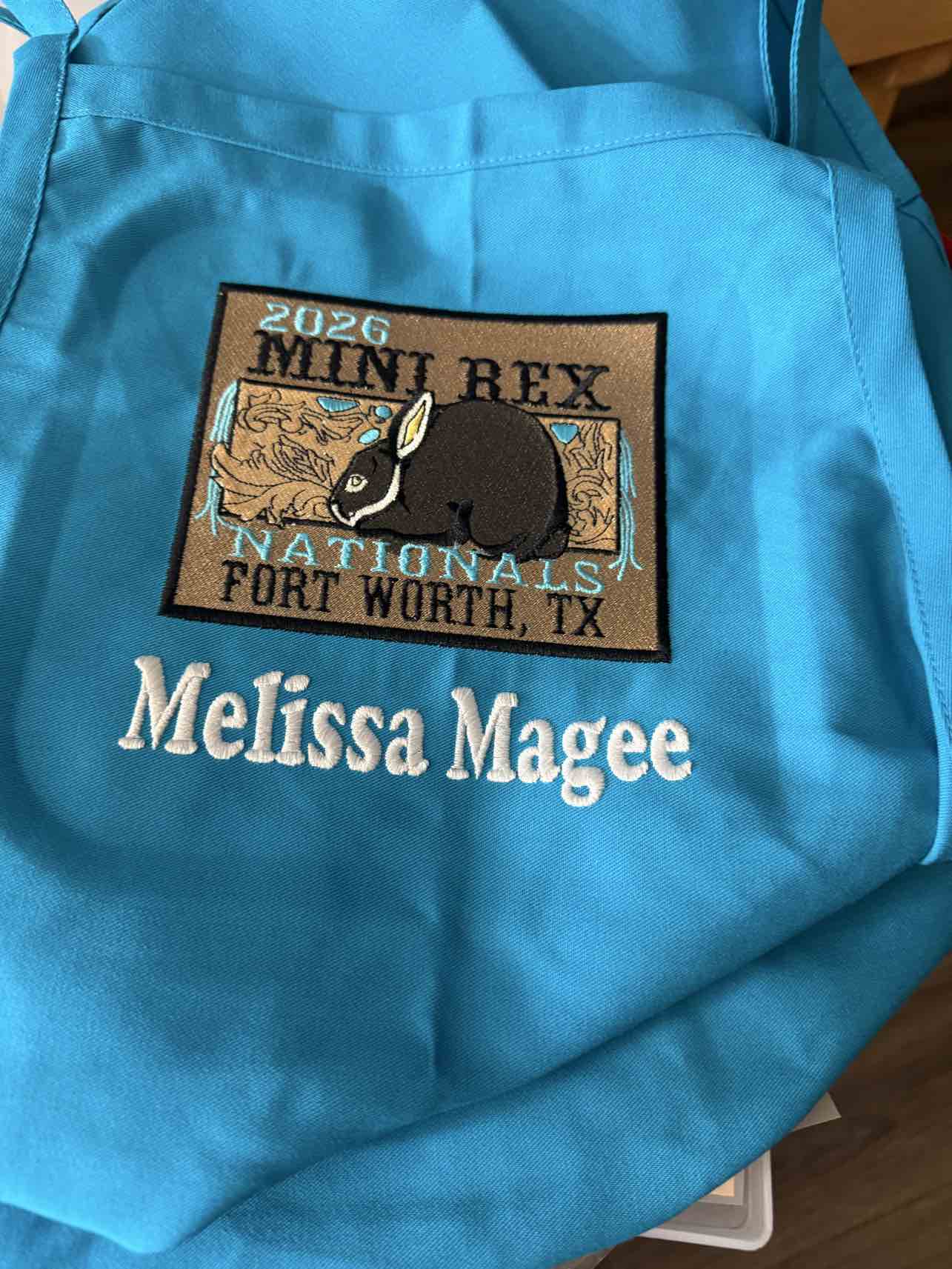 Turquoise bag with 2026 Mini Rex Nationals patch and personalized name