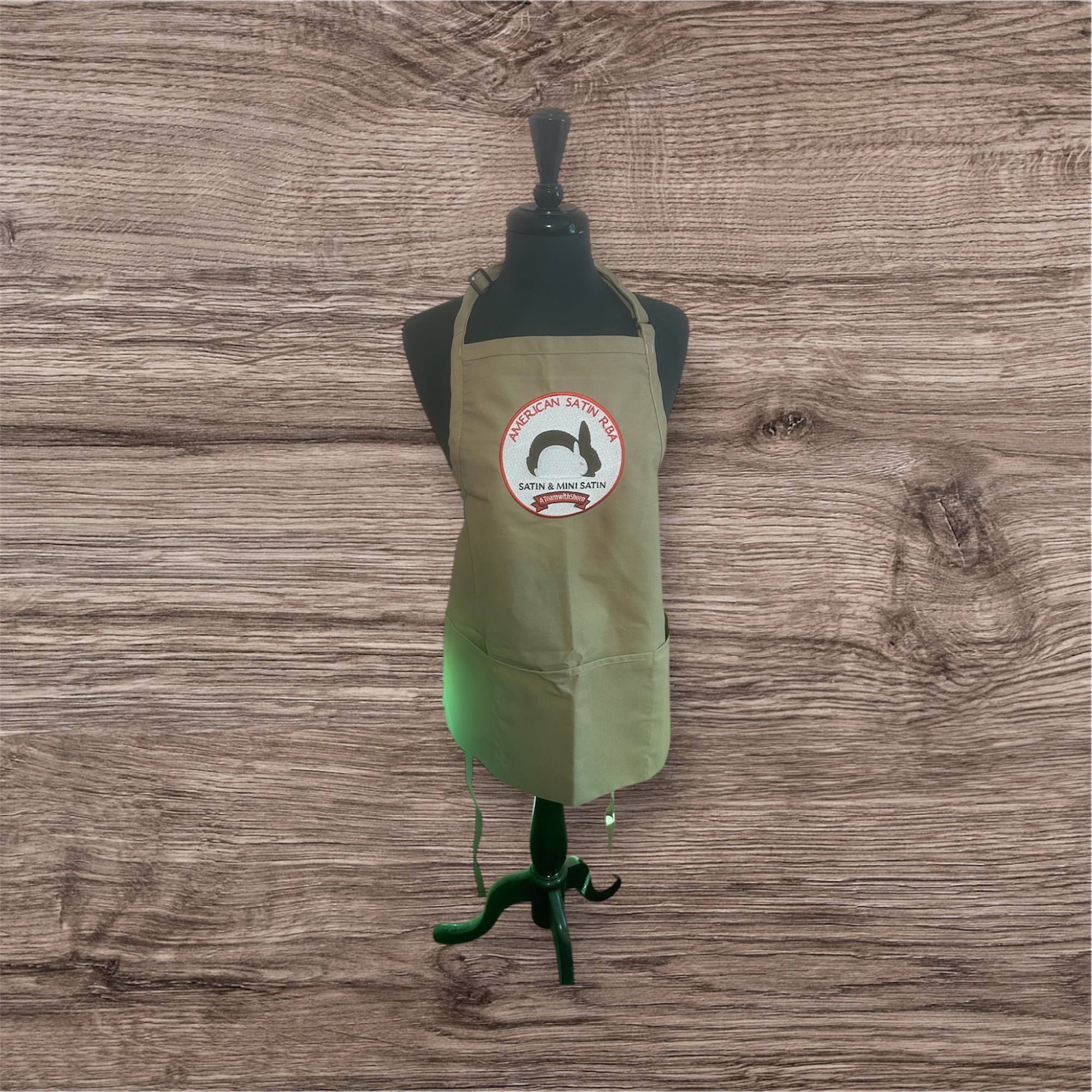 Tan apron with American Satin RBA circular logo patch