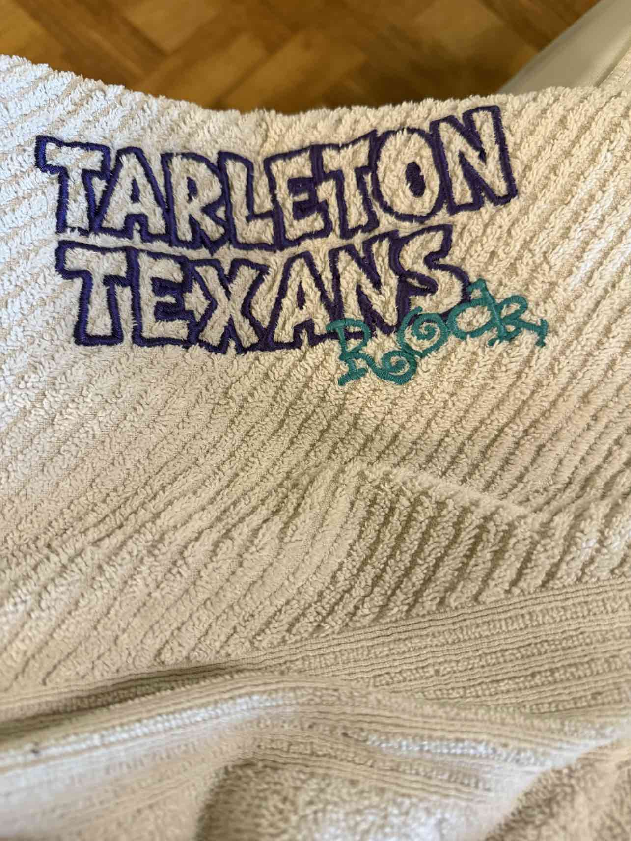 Cream towel with Tarleton Texans purple embroidery